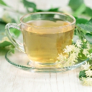 clear cupwith herbal tea infusion and saucer