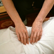 laying hands on back shiatsu treatment